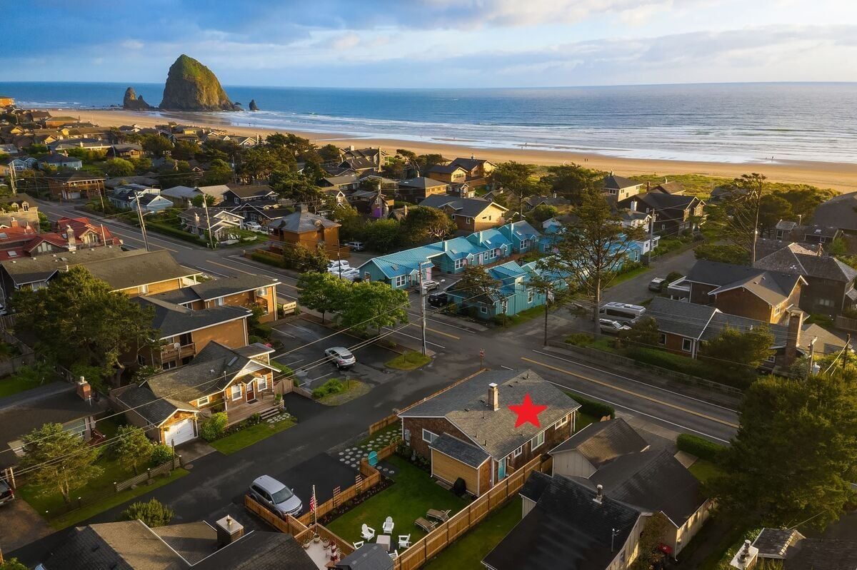 Aerial view of Beach Blessing cottage with Haystack Rock and the Pacific Ocean one block away